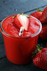 Fresh strawberry smoothie on wooden table