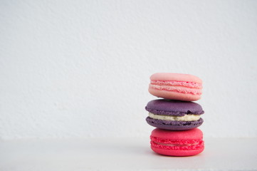 pink magenta purple colorful macaron french dessert with white cement