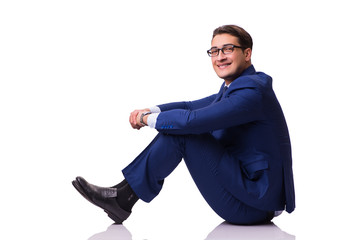 Businessman sitting on the floor isolated on white