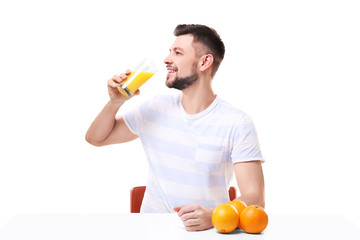 Fototapeta premium Handsome man posing with juice on white background