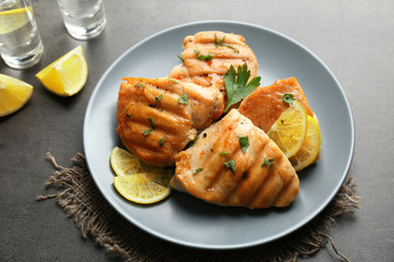 Plate of delicious tequila lime chicken on gray background