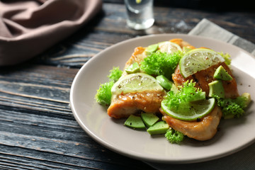 Plate of delicious tequila lime chicken on wooden background