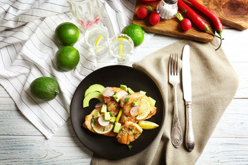 Fototapeta na wymiar Plate of delicious tequila lime chicken with ingredients on wooden background