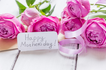 present design with Mother's day text and greeting-card on wooden desk