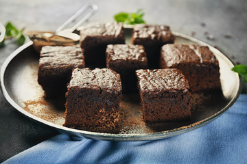 Metal tray with delicious cocoa brownies on table