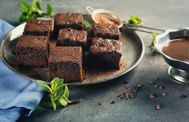 Metal tray with delicious cocoa brownies on table