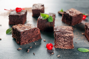 Delicious cocoa brownies on table