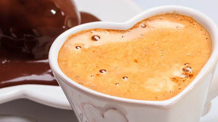 Closeup of cup of coffee and chocolate cake.