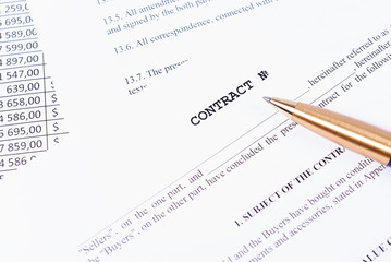 Pen lying on signed contract.