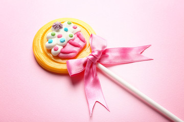Tasty lollipop on color background