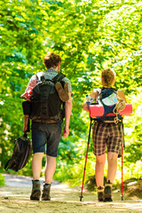 couple backpacker hiking in forest pathway