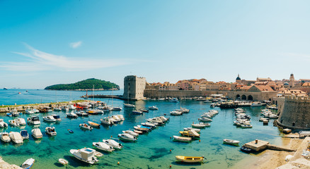 Fototapeta na wymiar The boat dock near the old city of Dubrovnik, Croatia. The harbor, a marina, near the ancient city.