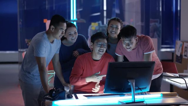  Portrait smiling Asian game developers in creative office