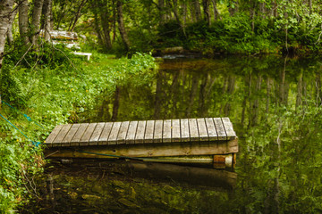 Fototapeta premium Old wooden pier on lake pond in summer