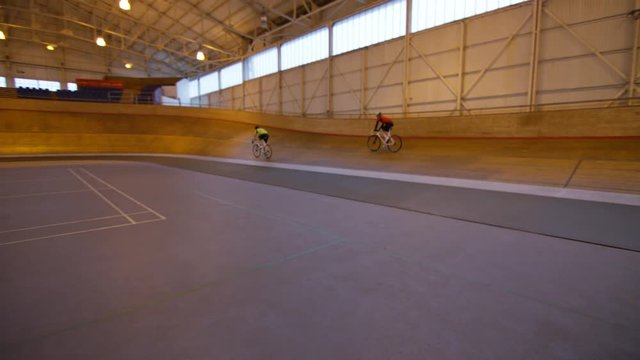  Competitive cyclists training on track in velodrome