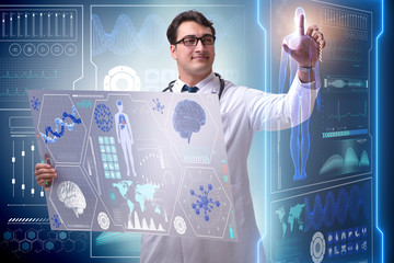 Young male doctor in futuristic medical concept