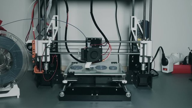 3d printer printing plastic parts gears and pulleys using pla filament