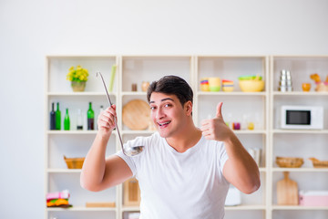 Young male cook working in the kitchen