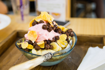 shaved ice with banana, chocolate and flakes cereal