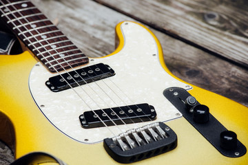 Fototapeta na wymiar Yellow Electric Guitar on Wood