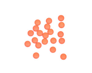 Round orange pills isolated on white background