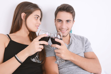 Couple drinking wine in bed.