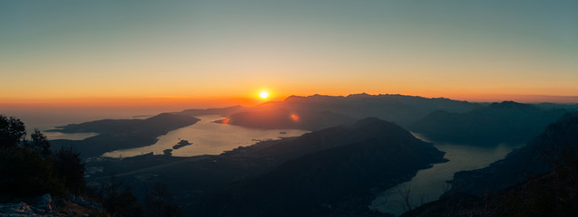 Fototapeta na wymiar Sunset in the mountains. Sunset in the Montenegrin mountains. Sun to sit down behind the mountains.