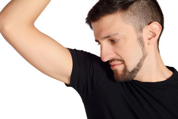 Man smelling his armpit.