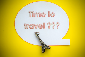 question: where to go on a trip? Time to travel?  travel banner on yellow background. Traveling mood. travel and vacations concept. small symbol of france. statuette, figurine of eiffel tower.