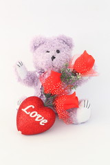 Purple teddy bear and red roses on a white background.