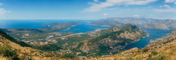 Fototapeta na wymiar Bay of Kotor from the heights. View from Mount Lovcen to the bay. View down from the observation platform on the mountain Lovcen. Mountains and bay in Montenegro. The liner near the old town of Kotor.