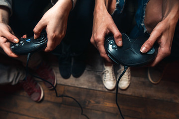 Video game competition of unrecognizable group of people with joysticks, close up view of hands....