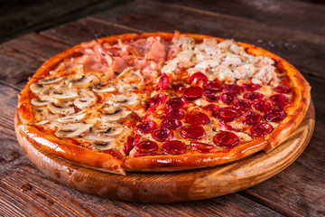 Junk food, bad habits. Pizza sliced on rustic wooden table background. Italian traditional meal