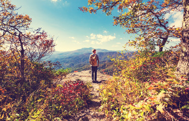 Man walking on the edge of a cliff