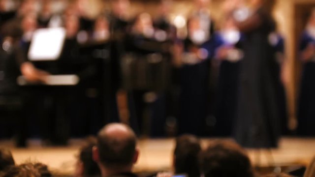 Audience in concert hall - people shooting performance on smartphone, music opera