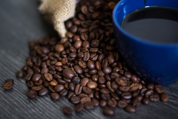 A cup of coffee on coffee beans