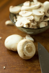 Champignon mushrooms on the wooden table. Selective focus