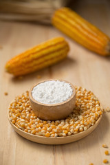 Corn flour in a bowl over a wooden table