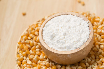 Corn flour in a bowl over a wooden table