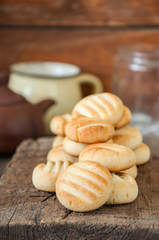 Close up of  heap of freshly baked rice flour ginger cookies on a wooden background.Copy space.