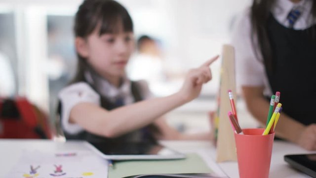  Young school children in class with little girl using abacus & computer table