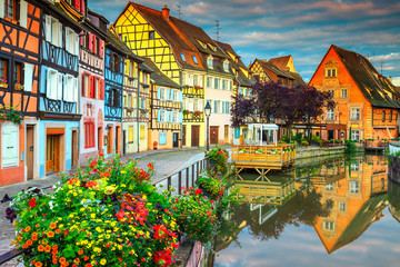 Famous medieval half-timbered facades reflecting in water, Colmar, France - obrazy, fototapety, plakaty