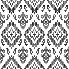 Vector illustration of the black and white colored ikat ornamental seamless pattern. Scribble texture. Design in modern ethic style.