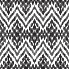 Vector illustration of the black and white colored ikat ornamental seamless pattern. Scribble texture. Design in ethic style.