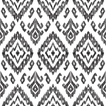 Vector illustration of the black and white colored ikat ornamental seamless pattern. Scribble texture. Design in modern ethic style.