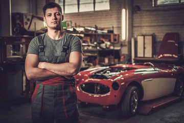 Mechanic in classic car restoration workshop