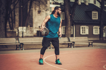 African-american streetball player practicing outdoors