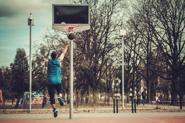 African-american streetball player practicing outdoors