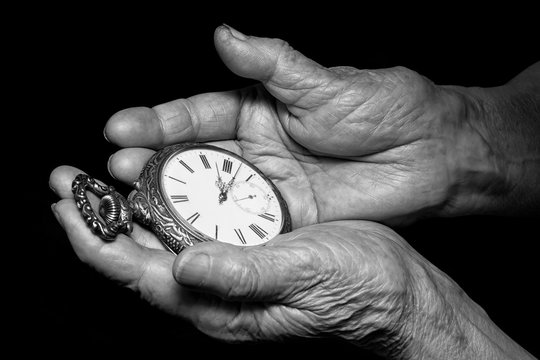 Senior Woman Hands Holding Ancient Clock. Aging Problems, Senior Age And Stream Of Time Theme.