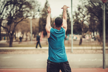 African-american streetball player practicing outdoors